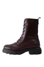 Load image into Gallery viewer, A dark burgundy leather lace-up ankle boot with a chunky black lug sole, shown in a side profile against a light gray background.
