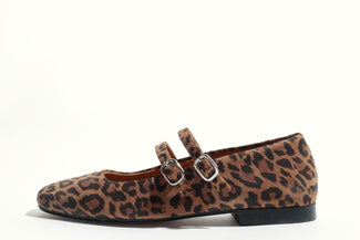Leopard print flat shoe with a buckle on a white background