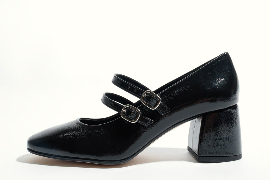 Black high-heeled shoe with a strap on a white background