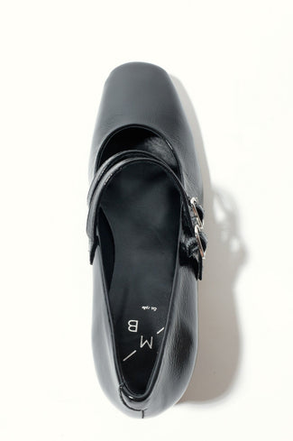 Black high-heeled shoe with a strap on a white background