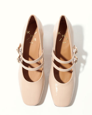 Beige shoe with a strap on a white background