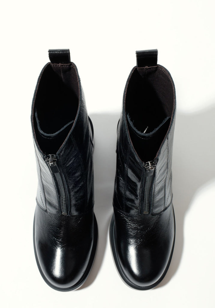 Pair of black leather boots on a white background