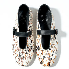 Load image into Gallery viewer, Pair of animal print shoes with black straps on a white background
