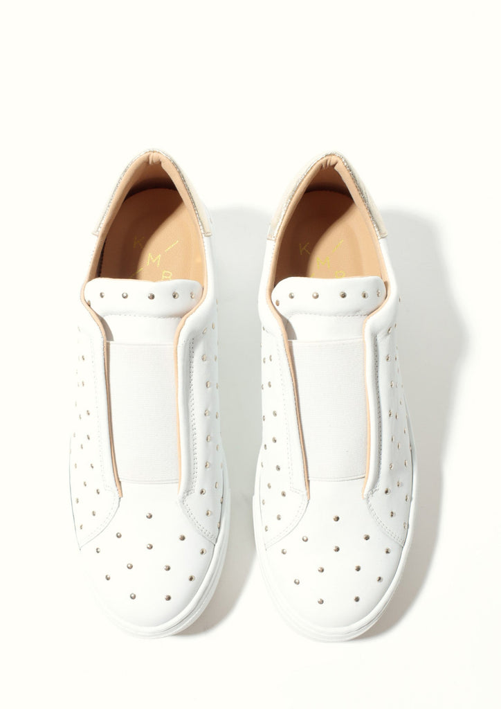 Pair of white loafers on a white background