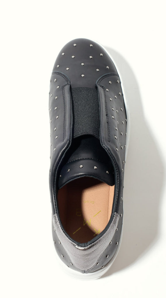 Black slip-on shoe with black sole on a white background