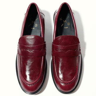 Burgundy loafer shoe on a white background