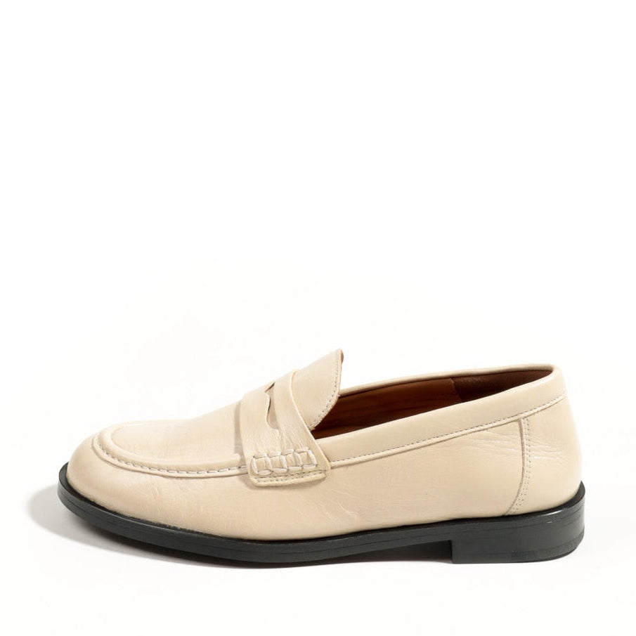 Beige loafer shoe on a white background