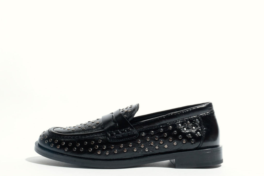 Black loafer shoe with studded details on a white background