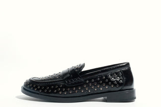 Black loafer shoe with studded details on a white background