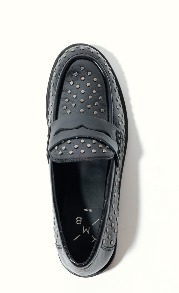 Black loafers with studded details on a white background