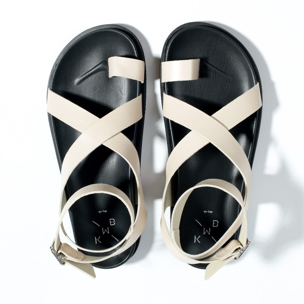 Black sandals with white straps on a white background