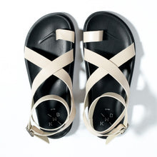 Load image into Gallery viewer, Black sandals with white straps on a white background
