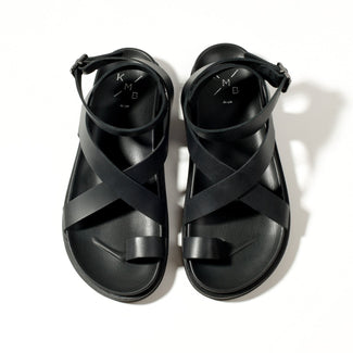 Black slip-on shoe on a white background