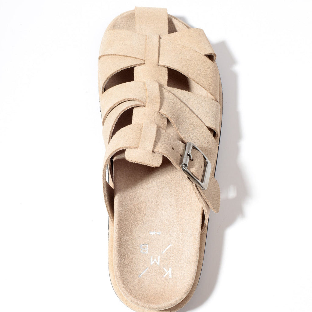 Beige sandal with woven design on a white background