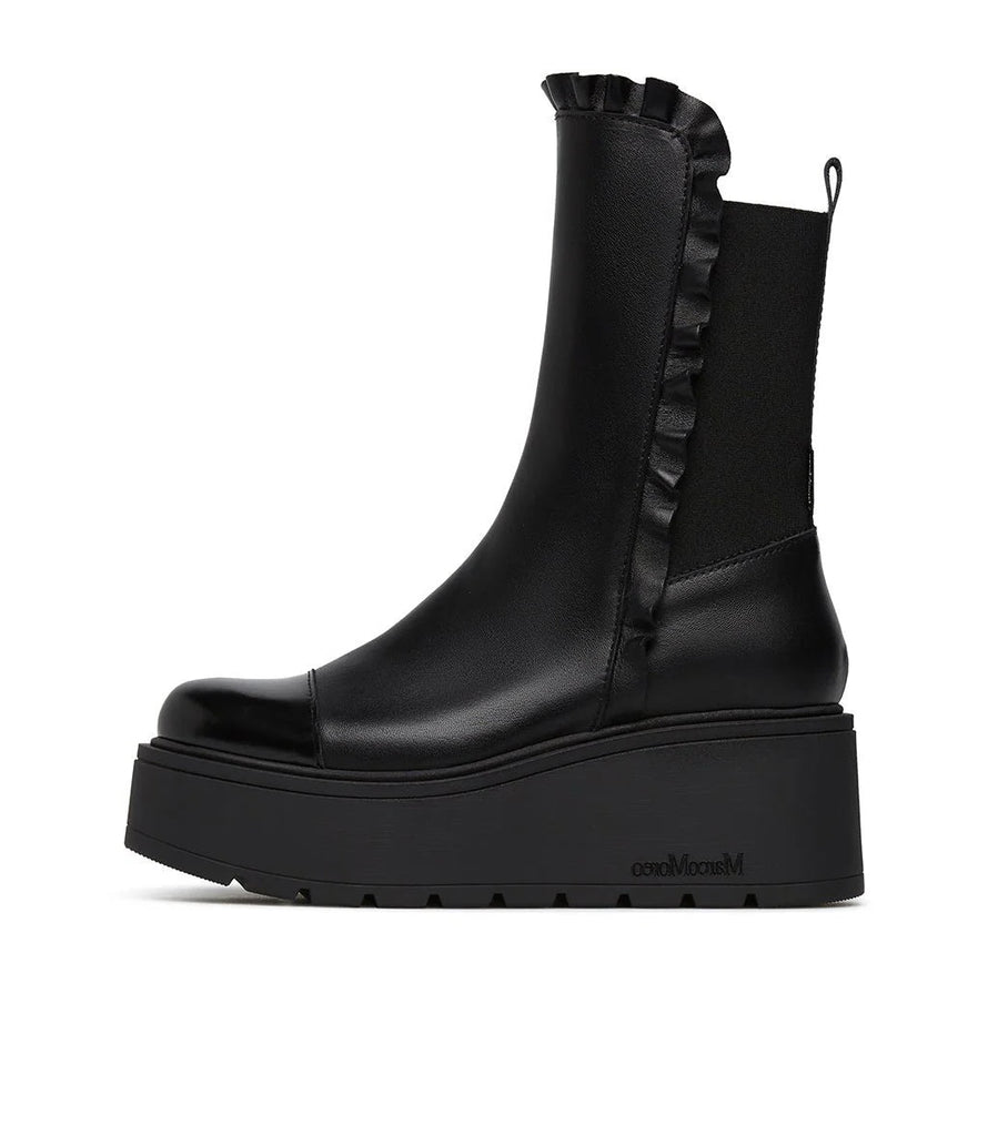 Black platform boot with ruffled detail on a white background
