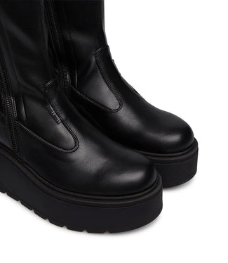 Black knee-high platform boot on a white background