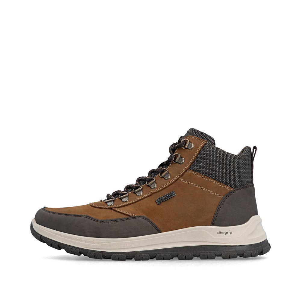 Brown and black hiking boot on a white background