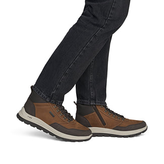 Brown and black hiking boot on a white background