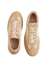 Load image into Gallery viewer, Pair of beige and white sneakers on a wooden surface with a neutral background
