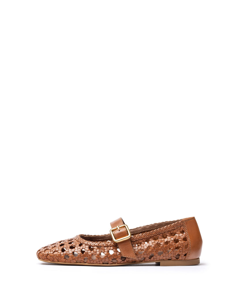 Bronze  flat shoe with a gold buckle on a white background