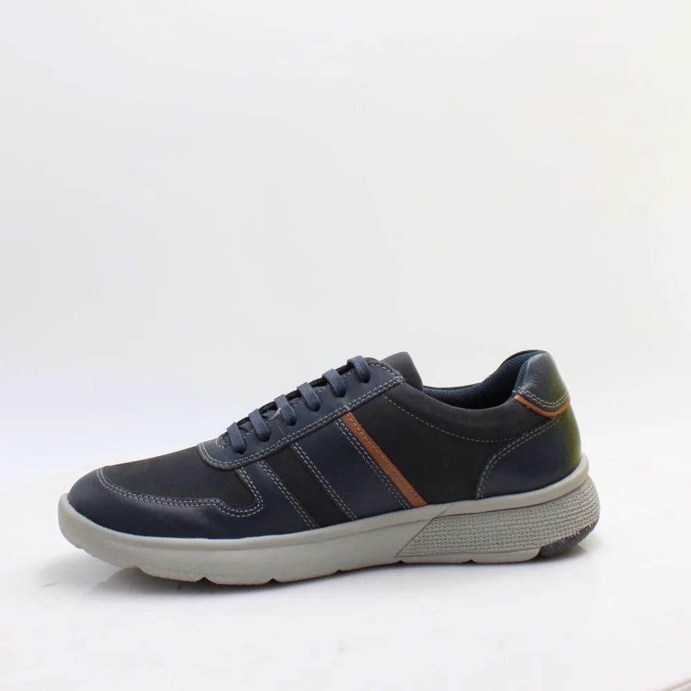 Navy blue sneaker with a white sole on a light gray background