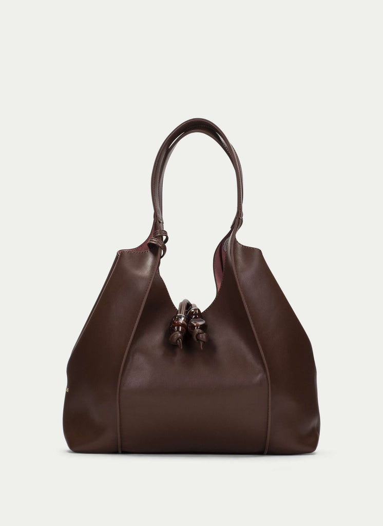 Brown leather handbag on a light gray background