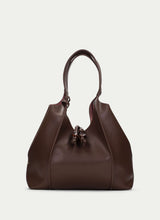 Load image into Gallery viewer, Brown leather handbag on a light gray background
