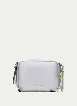 Load image into Gallery viewer, Silver crossbody bag with a chain detail on a light gray background
