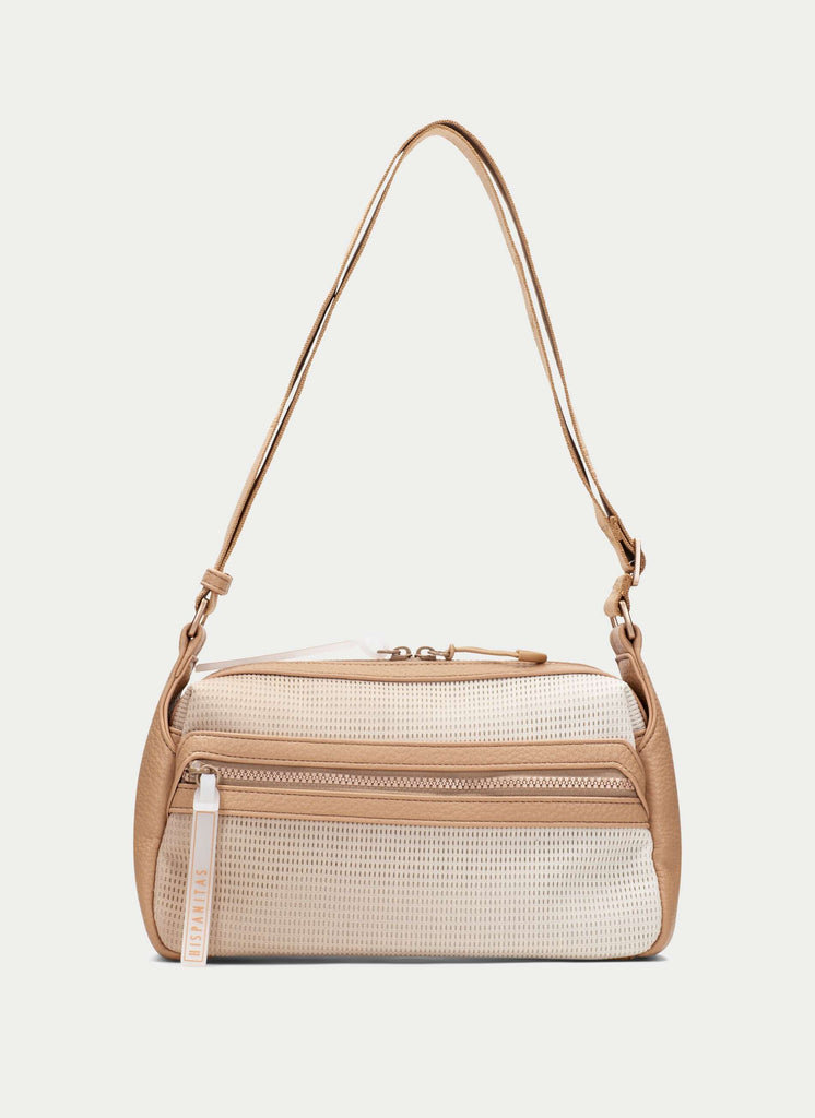 Beige and white handbag with a strap on a light gray background