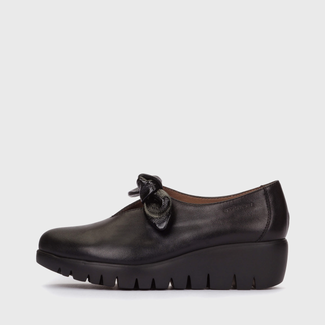 Black shoe with a bow on a white background