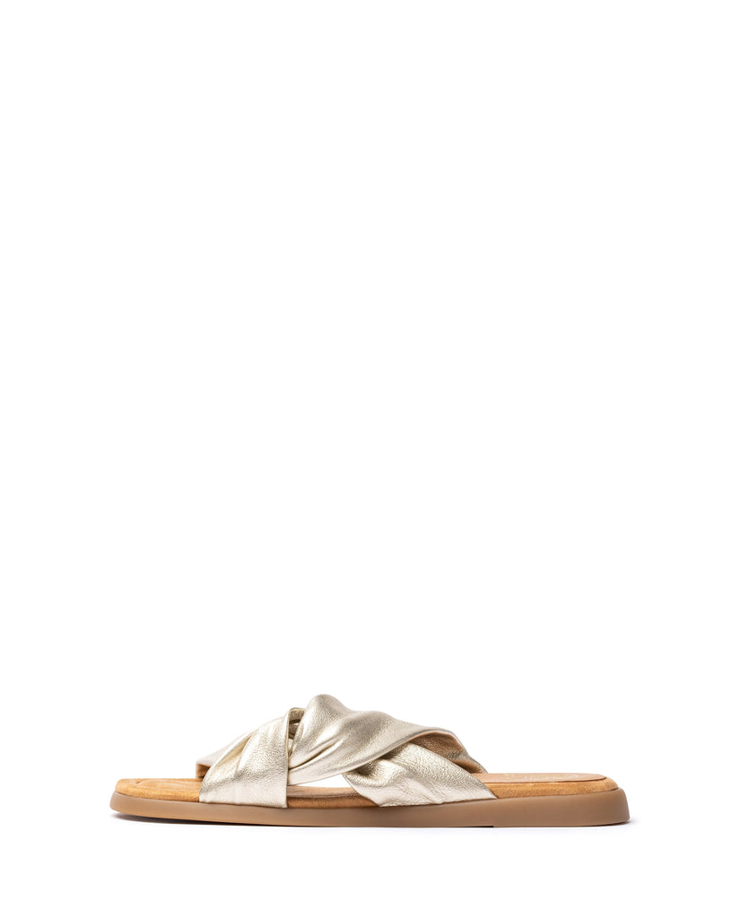 Gold sandal with wooden sole on a white background