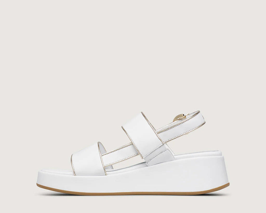 White sandal with platform sole on a light gray background