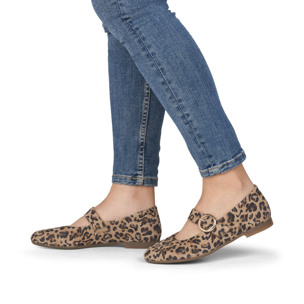 Leopard print flats worn with blue jeans on a white background
