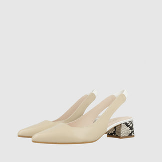 Beige shoe with a patterned heel on a white background