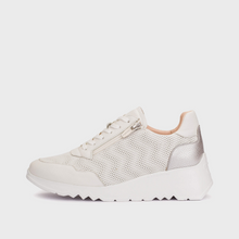 Load image into Gallery viewer, White sneakers worn on a wooden dock with a marina background

