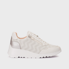Load image into Gallery viewer, White sneakers worn on a wooden dock with a marina background
