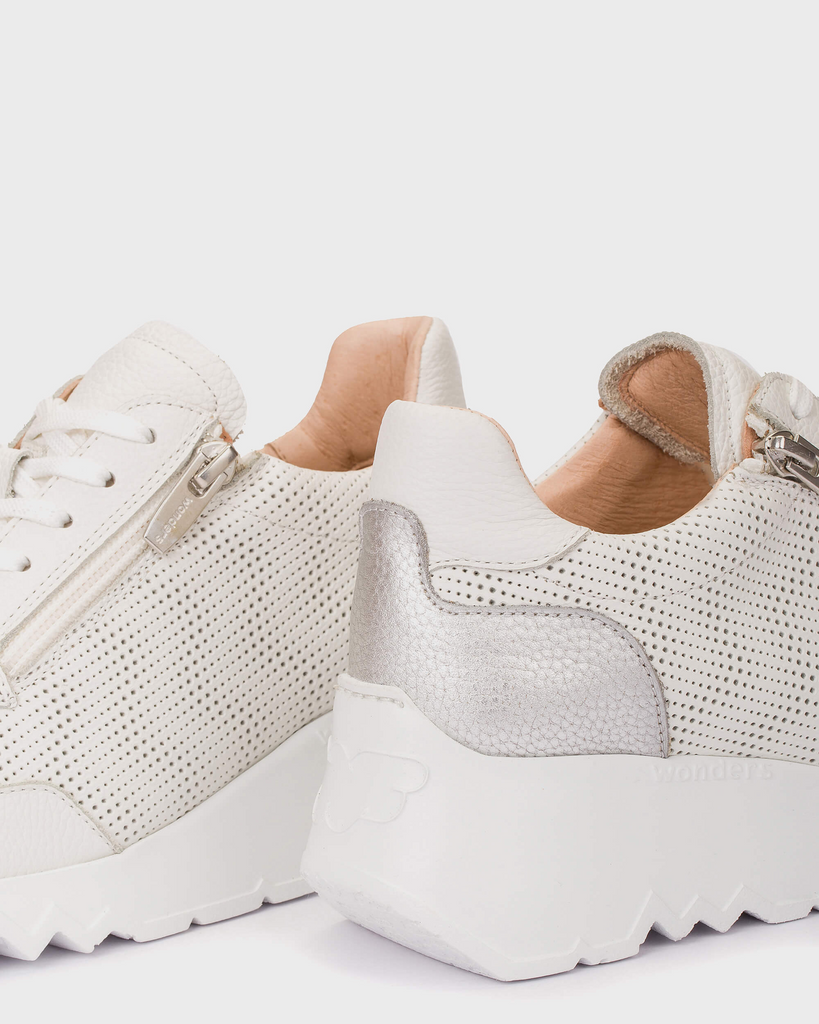 White sneakers with textured design on a light background