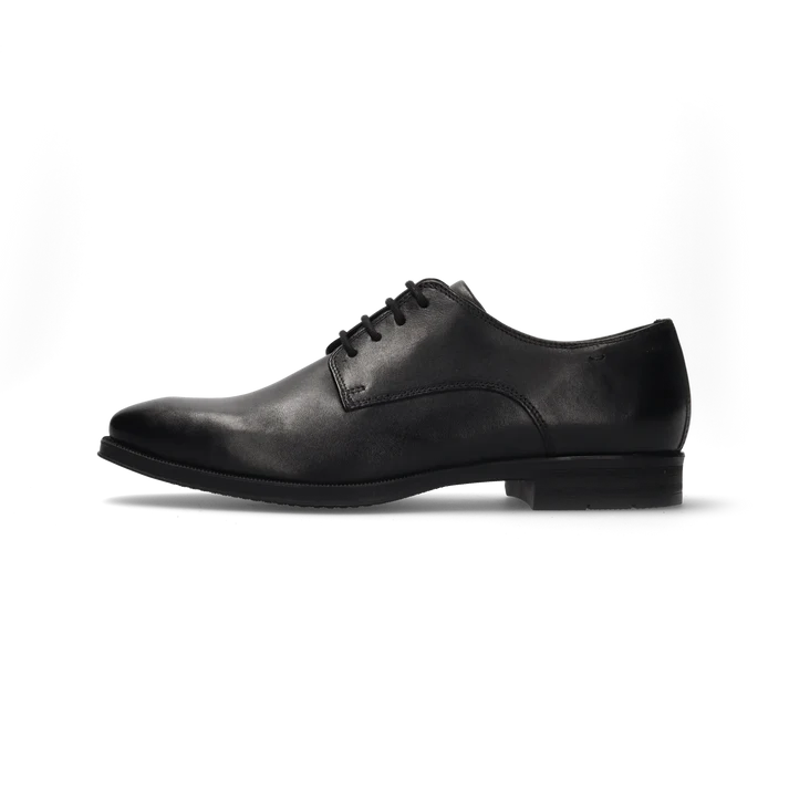 Black leather dress shoe on a white background