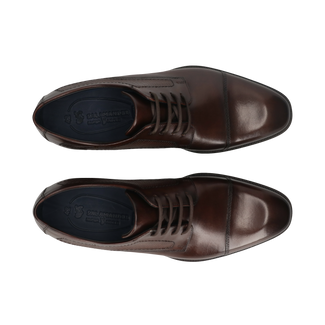 Brown leather dress shoe on a white background