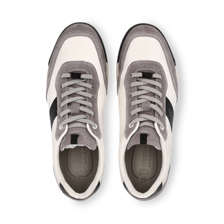 Gray and white sneaker with a black stripe on a white background