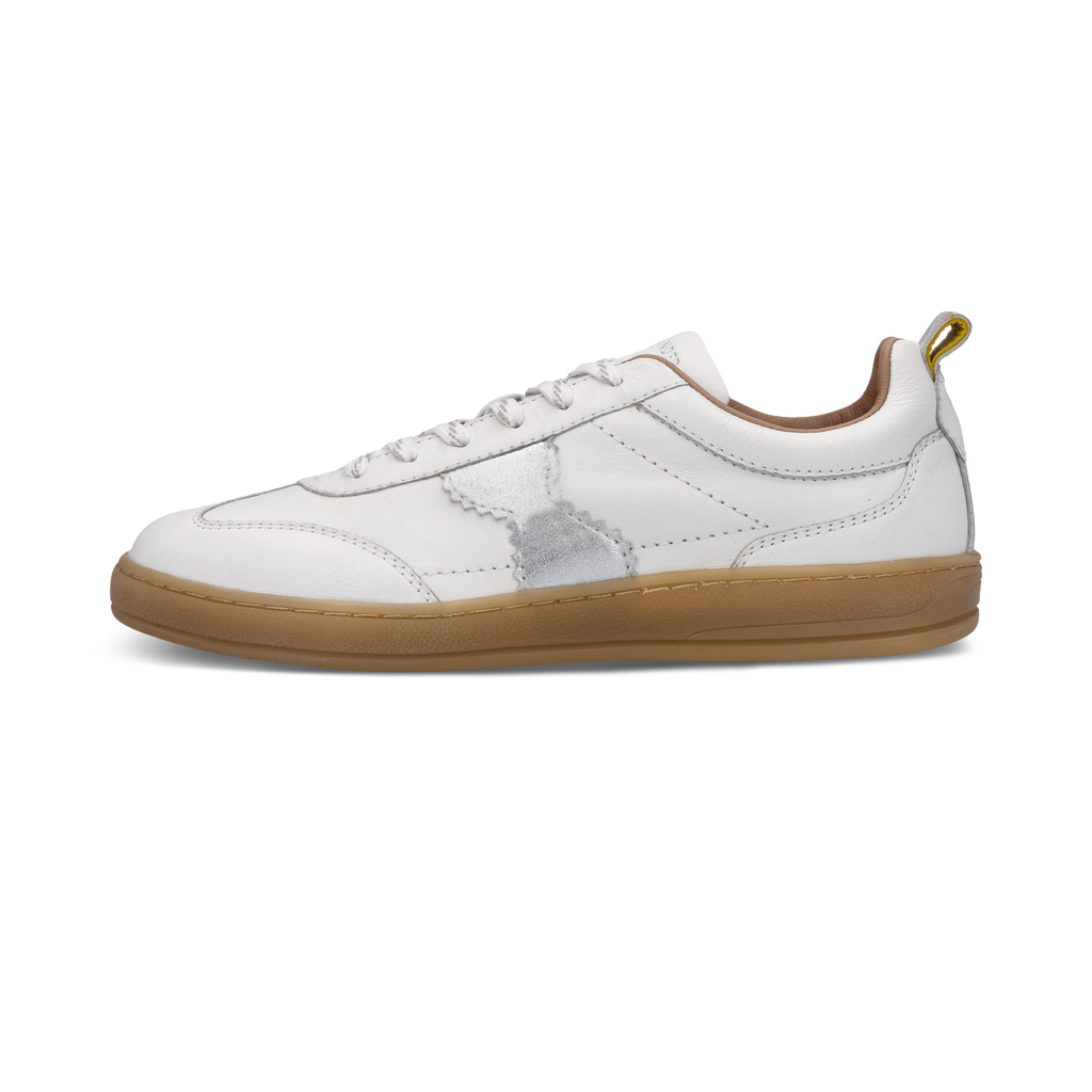 White sneaker with brown sole on a white background