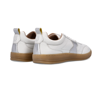 White sneaker with brown sole on a white background