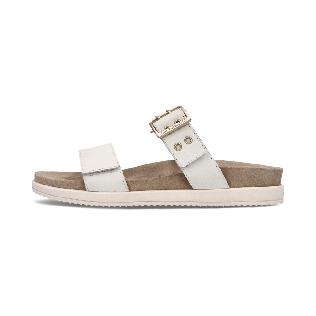 White sandal with a brown sole on a white background