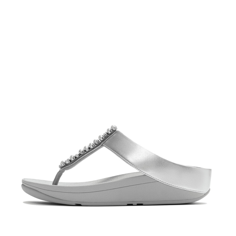Silver sandal with embellishments on a white background