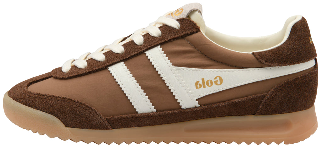 A brown suede and canvas sneaker with white side stripes, white laces, and a gum sole. The brand name 'Gola' is printed in gold on the side.