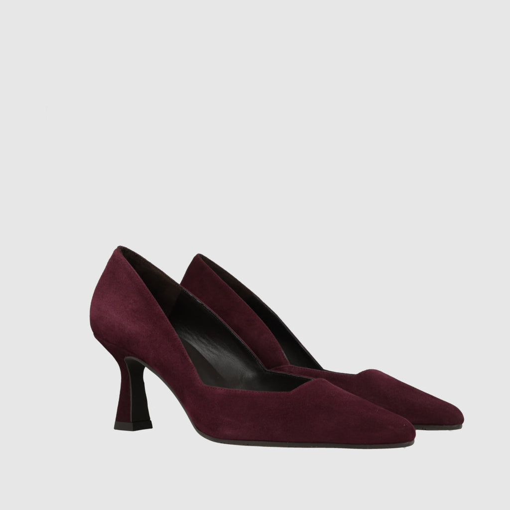 A pair of pointed-toe pumps in deep burgundy suede with a chunky block heel, shown against a light gray background.