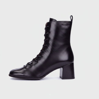 A black leather lace-up ankle boot with a chunky block heel, shown in profile against a light gray background.