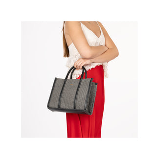 Black woven handbag with a strap on a white background