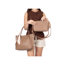 Load image into Gallery viewer, Woman holding two brown handbags against a white background
