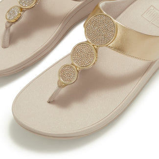 Beige sandal with a decorative strap on a white background